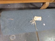 A large roll of unused carpet,