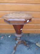 A 19thC octagonal walnut work/games table with chess board top opening to reveal fitted interior
