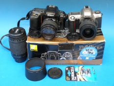A Nikon F65 SLR camera with 28-80mm lens together with an F50 with 35-80mm lens and a 70-300mm