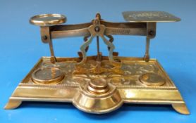 A set of cast brass postage scales with rates to pan and cast foliate base