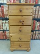 A pine chest of five straight drawers (H90 x W42 x D38cm)