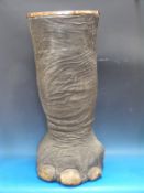 An exceptionally large taxidermy elephant leg stick stand with wooden and copper collar stamped