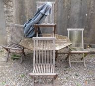 An octagonal teak garden table parasol and four chairs
