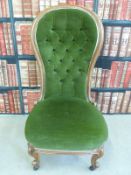 A balloon back chair with green button-back upholstery,