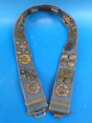 A military trophy belt mounted with Air Force badges etc
