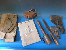 A quantity of militaria including stick grenade, pistol holsters,