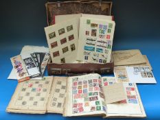 A suitcase containing various stamp albums, covers etc,