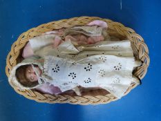 A Victorian doll, approximately 20cm in length, with open mouth, teeth,