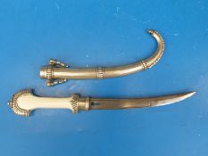A Moroccan dagger in curved white metal  scabbard with Moroccan ram's head silver marks to all