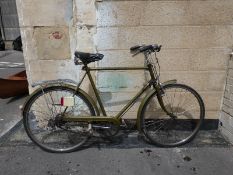 A gentleman's green Raleigh bicycle