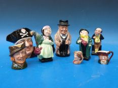 A collection of Royal Doulton Toby and character jugs and Dickens figures
