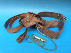 A WWI Sam Brown belt together with a leather sword frog and a Metropolitan Police whistle