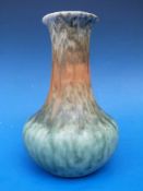 A Ruskin bottle form vase with mottled green decoration,