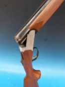 A 20 bore Rota L Sarezzo over and under shotgun with ornate engraving of dogs and birds with single