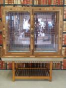 An inlaid display cabinet with perspex top and sides and mirrored back,