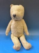 A straw filled mohair teddy bear with articulated limbs