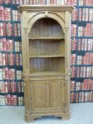 A pine corner display cabinet with three-shelf top and cupboards under (height 203.