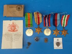 A group of five WWII medals and badges in named issue box, Mr H.J.