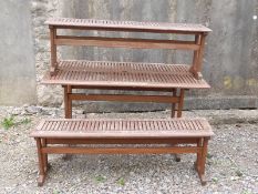 A teak table and two benches