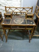 An oriental bamboo and lacquer side table or desk with two small drawers to top and single drawer