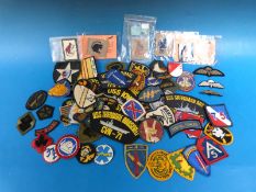 A quantity of US military and other fabric patches/badges to include Desert Storm, Desert Rats, USS,