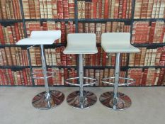 Three leather upholstered chrome bar stools