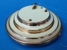 A green enamel and gilt musical compact plays 'La Vie en Rose'