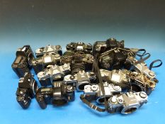 A quantity of SLR cameras and lenses including Pentax, Canon AE1, Nikkormat,