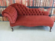 A red upholstered chaise longue