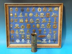 A framed and glazed set of military badges to include 9th Lancers, 10th Royal Hussars,
