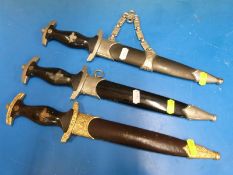 Three replica Nazi German daggers comprising two SS and one SA