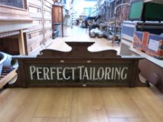 A vintage 'Perfect Tailoring' mahogany and illuminated glass shop sign (width 120cm)