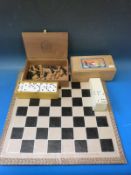 An ebonised boxwood chess set and board,