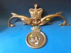 A brass HMS Dolphin tampion (height 22cm) together with a painted aluminium Naval dolphin insignia
