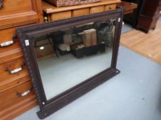 A late 19th/early 20th century carved oak framed over mantel mirrow with bevelled glass and two