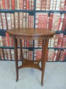 An Edwardian oval inlaid table with shaped undershelf together with a leather inset wine table and
