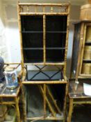 A bamboo and lacquer display cabinet with double door cupboard to top and similar cupboard to base