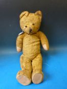 A vintage growling straw filled plush teddy bear,