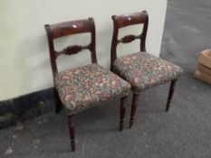 A pair of upholstered dining chairs