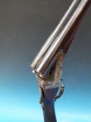 A 12 bore Cogswell & Harrison side by side shotgun, serial number 56099 in original leather case.