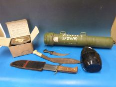 A quantity of militaria to include camouflage trousers,