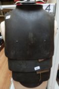 A set of German WWI body armour including original webbing, breast plate and three lower plates.