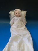 An Armand Marseille bisque headed doll with closed mouth and fixed brown eyes in full lace dress