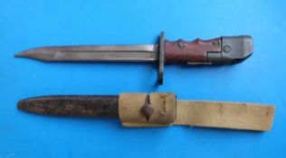 A British No 7 Mk 1/L bayonet and scabbard, 1944-48, with swivelling pommel and red composite grips,