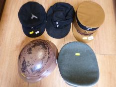 A quantity of German WW2 style headgear including helmet bearing Nazi inscription,