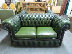 A green leather two-seat Chesterfield sofa (length 153cm)