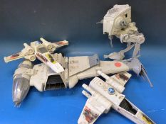 A collection of Star Wars spaceships and action figures including the Millennium Falcon,