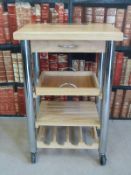 A light oak and chrome hostess trolley and an oak three basket storage unit