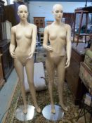 Two female shop display mannequins and stands