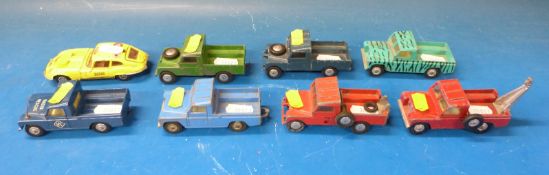 Seven Corgi diecast model Land Rovers together with a Corgi E-type Jaguar
